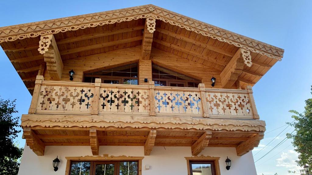 a building with a balcony on top of it at Chalet Bakuriani in Bakuriani