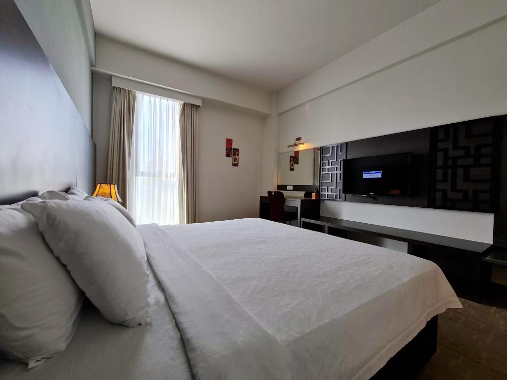 Postel nebo postele na pokoji v ubytování Swan Garden Hotel