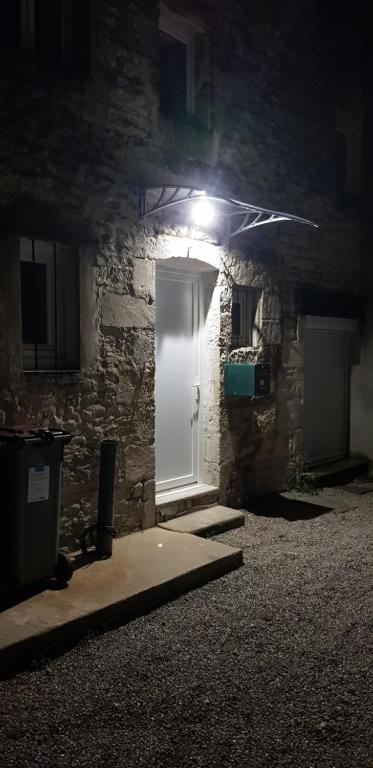 a white door in a stone building at night at Escapade Niortaise - Studios climatisés hyper-centre de Niort in Niort