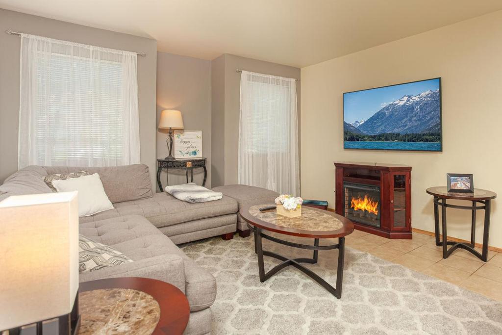 a living room with a couch and a fireplace at Walk to Downtown Leavenworth * Sleeps 6 + Pets * Ground Level Gem! in Leavenworth