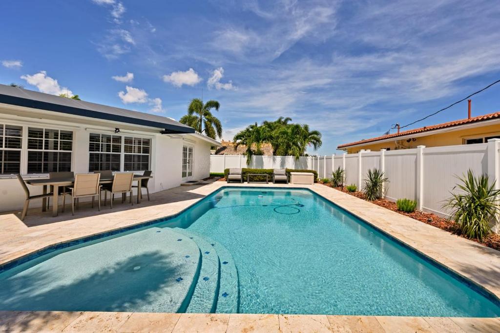 a swimming pool in the backyard of a house at Salt Life Beach Cottage Sleeps 8 Heated Pool in Pompano Beach