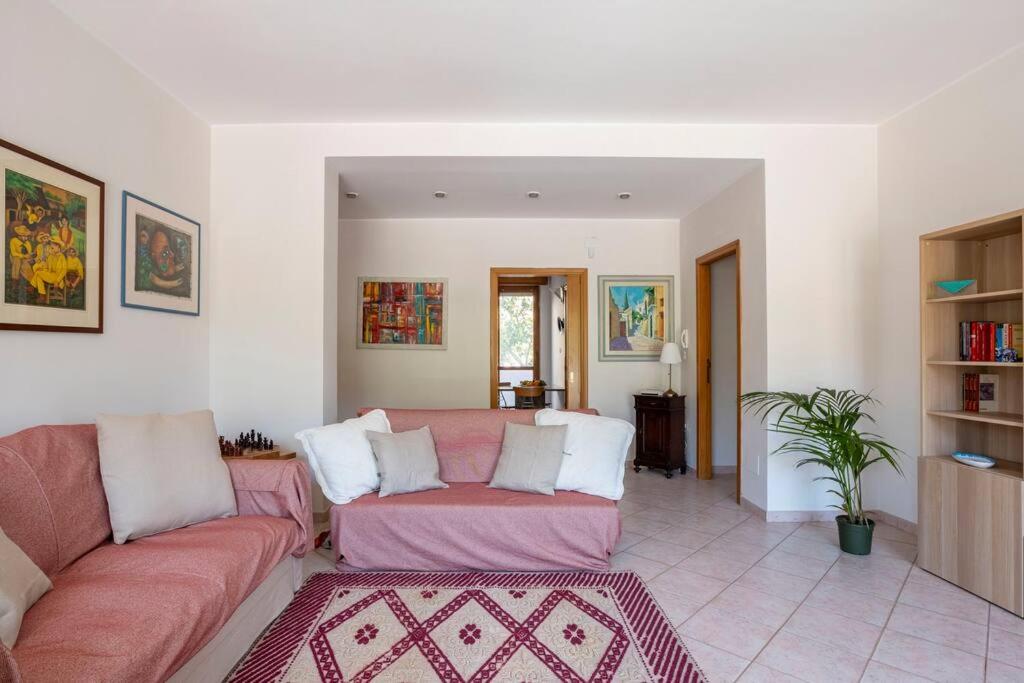 a living room with a couch and a table at Tangerine Tree House in Cagliari