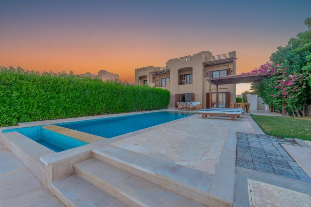 a swimming pool in the backyard of a house at 3BR Family Villa in Sabina, El Gouna. Lagoon & Private Pool in Hurghada