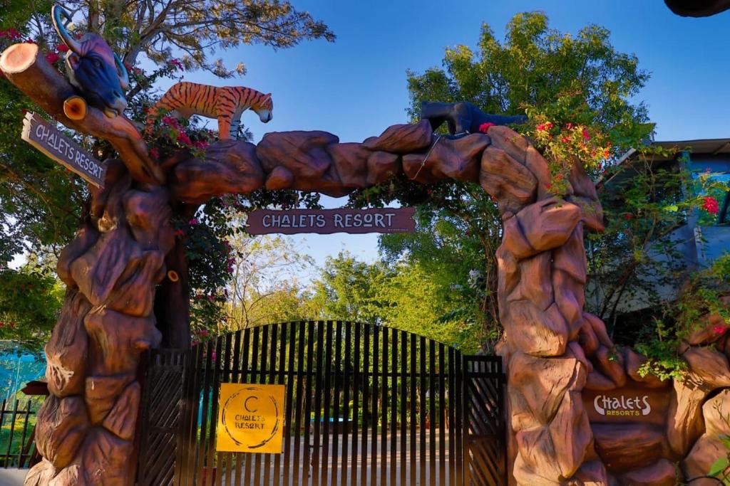 an entrance to a childrens resort with a wooden arch at Chalets Resort Masinagudi in Ooty