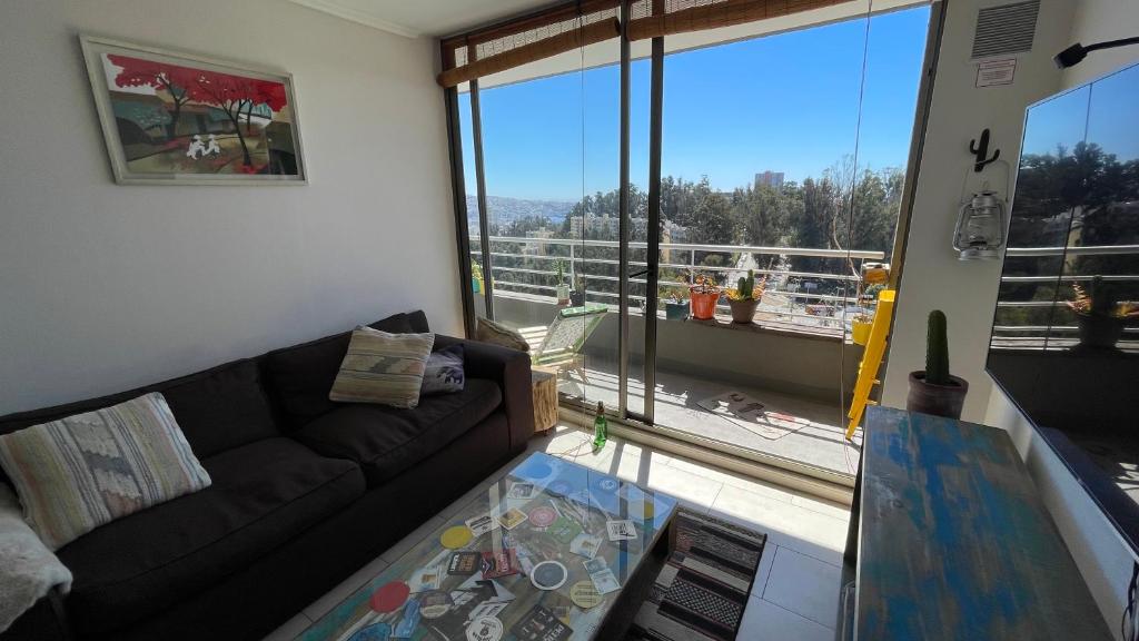 ein Wohnzimmer mit einem Sofa und einem großen Fenster in der Unterkunft Vista Valparaíso Barrio Inglés in Valparaíso
