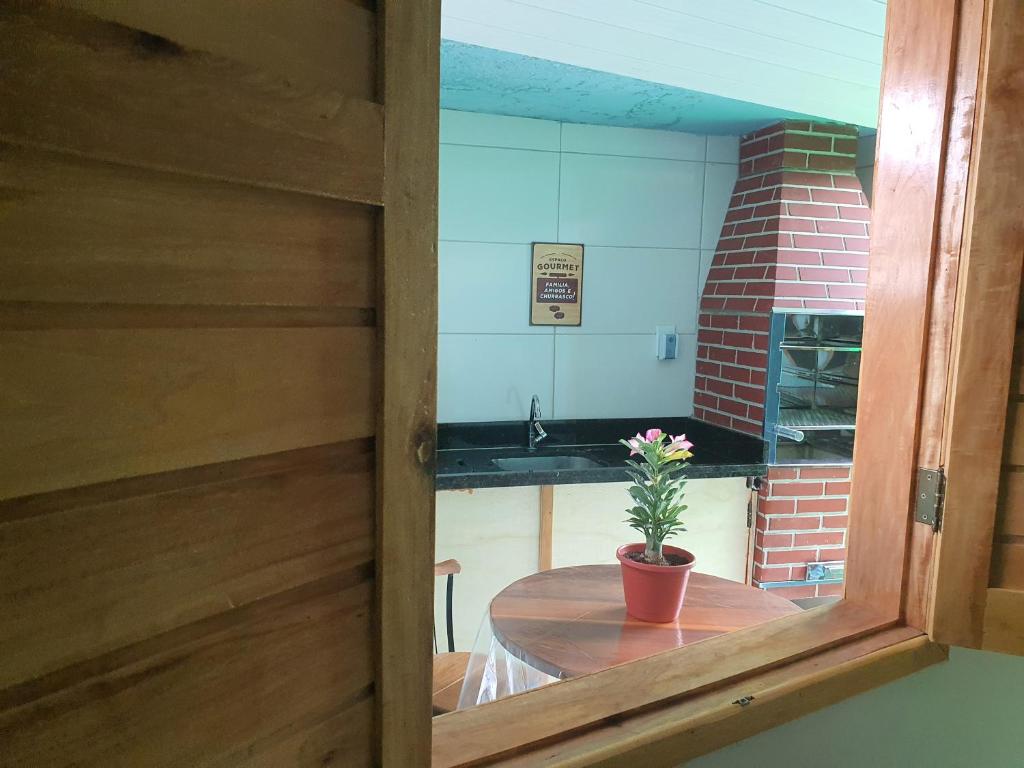 una habitación con una mesa con una maceta. en Nesga Village en Lençóis