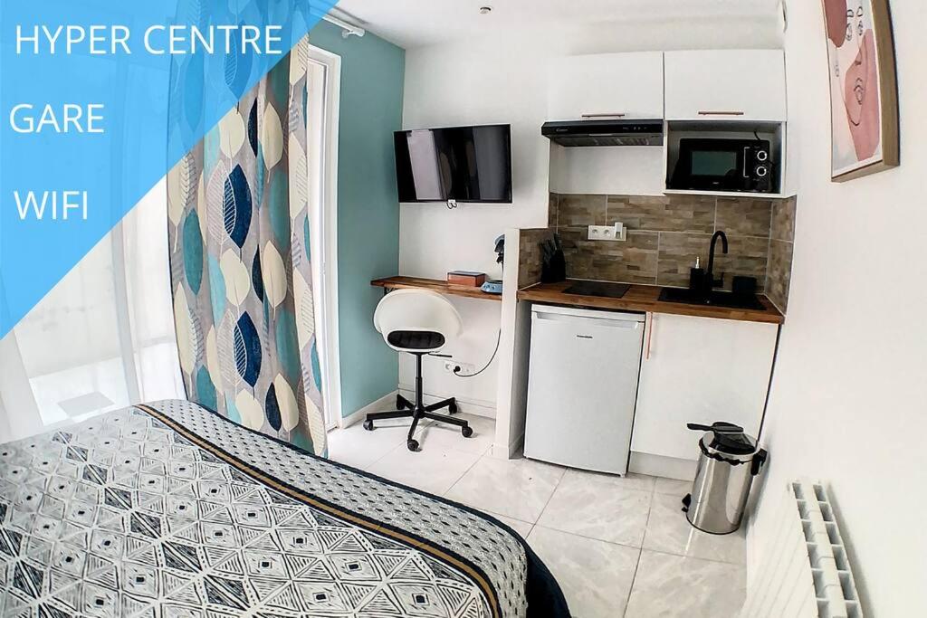 une petite cuisine avec un évier et une table dans l'établissement STUDIO COSY GARE AMIENS TOUT ÉQUIPÉ WIFI NETFLIX 2PERS, à Amiens