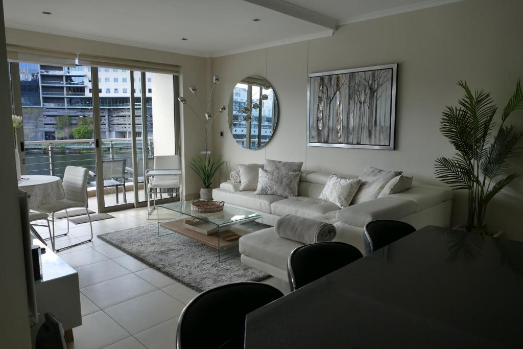 a living room with a couch and a table at Little Venice Self Catering in Bellville