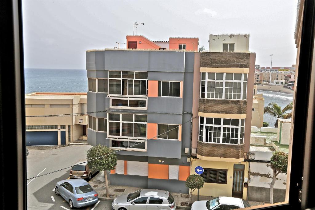 a view of a building with cars parked in a parking lot at Apartment Vasco de Gama in Telde