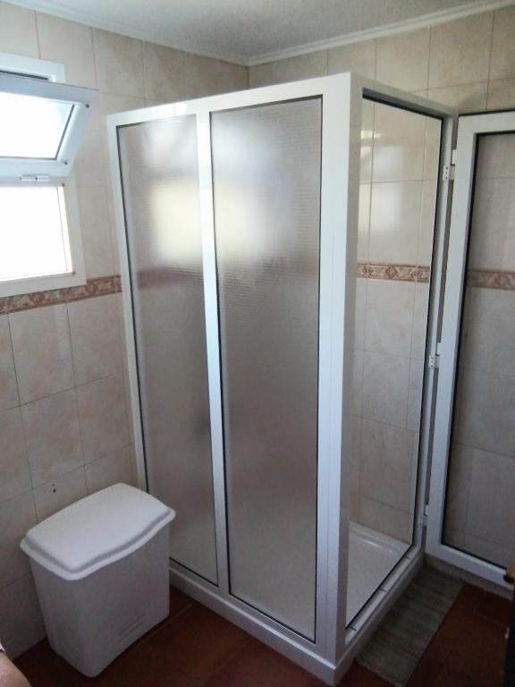 a bathroom with a shower and a toilet at Casa Dos Mosteiros in Mosteiros