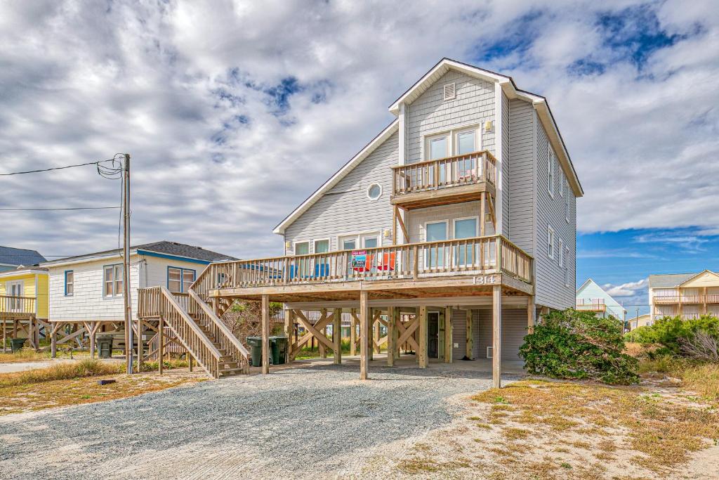 a large house with a deck on the side of it at Whaley Topsail Beach in Topsail Beach
