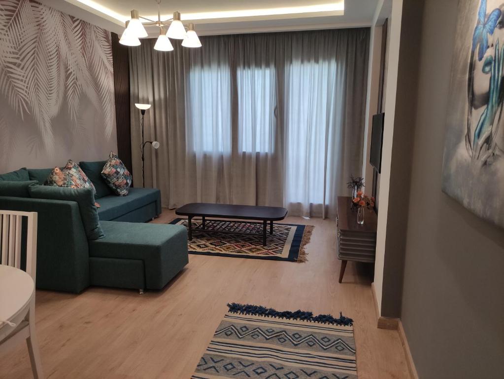 a living room with a couch and a table at Luxury Stay in Sheikh Zayed