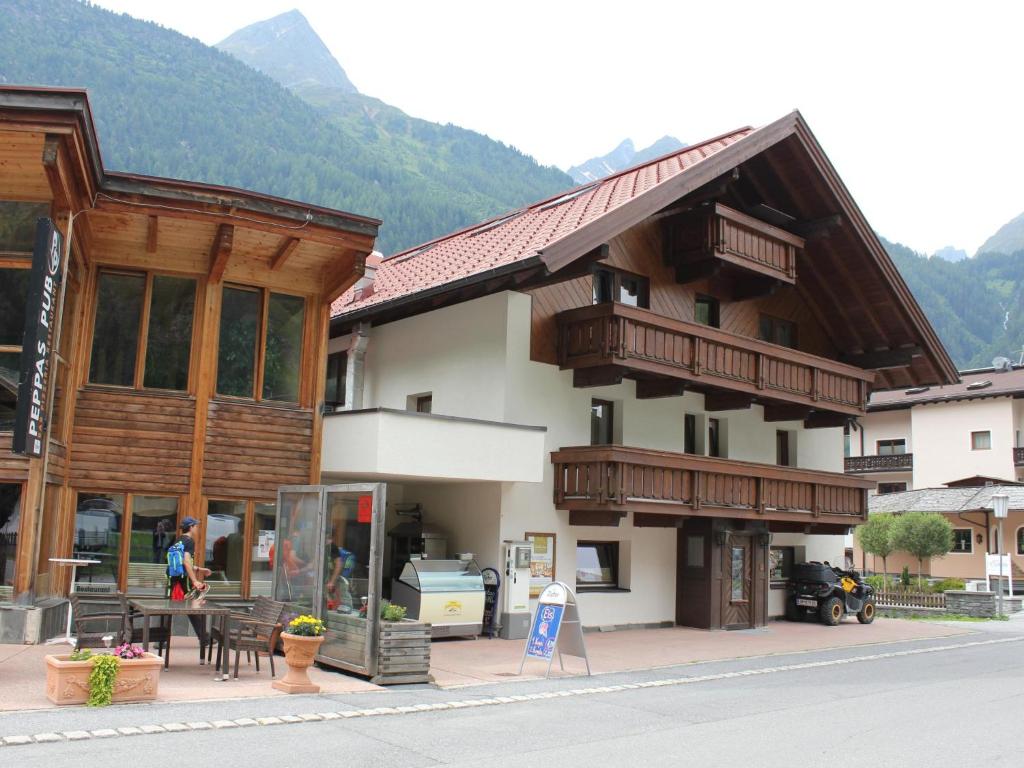 a large building in a town with mountains in the background at Haus Daheim II in Winkle
