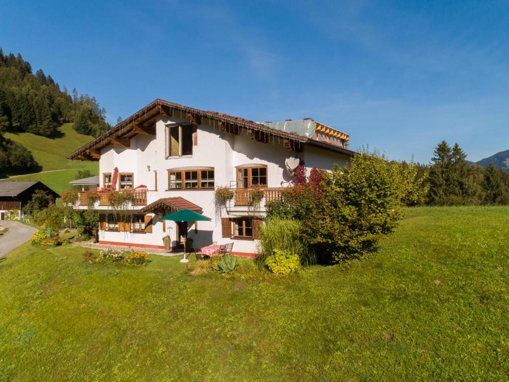 a large white house in a green field at Susanne in Bürserberg