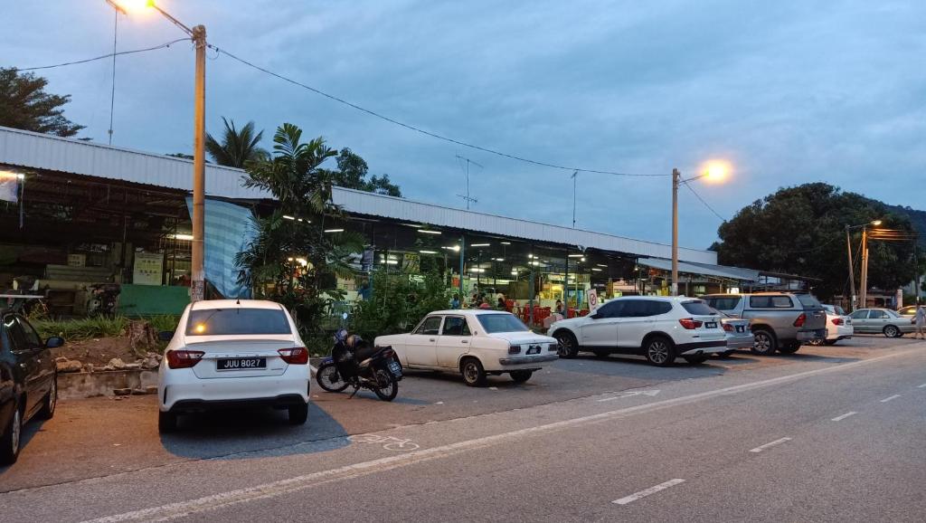 a group of cars parked on the side of a street at Snoopy homestay Two Bedroom in Batu Pahat