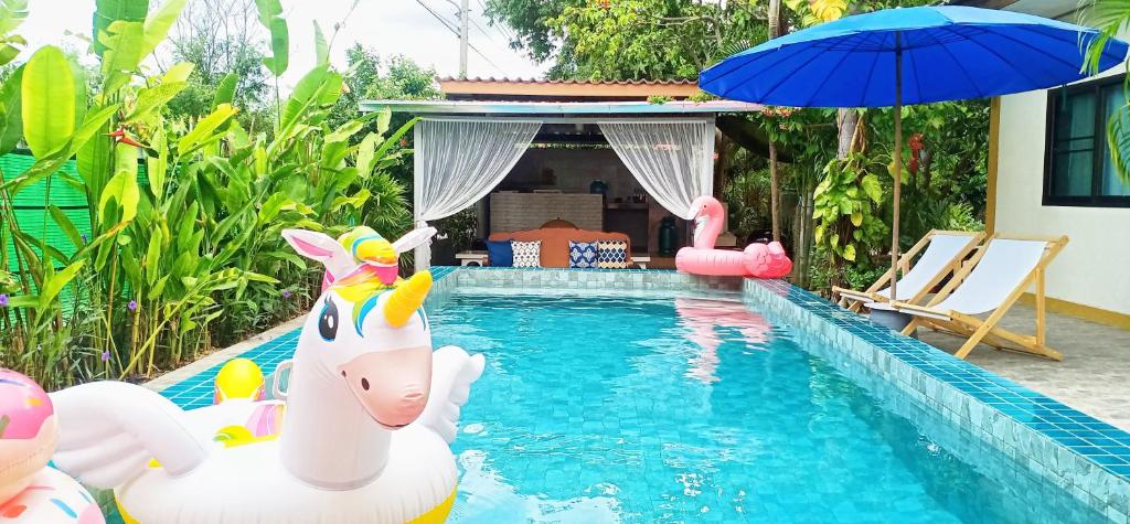 a pool with a toy unicorn in the water at Sweet Floresta Pool Villa in Sattahip