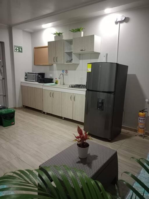 a kitchen with a refrigerator and a table in it at Apartamento cómodo y confortable in San Andrés