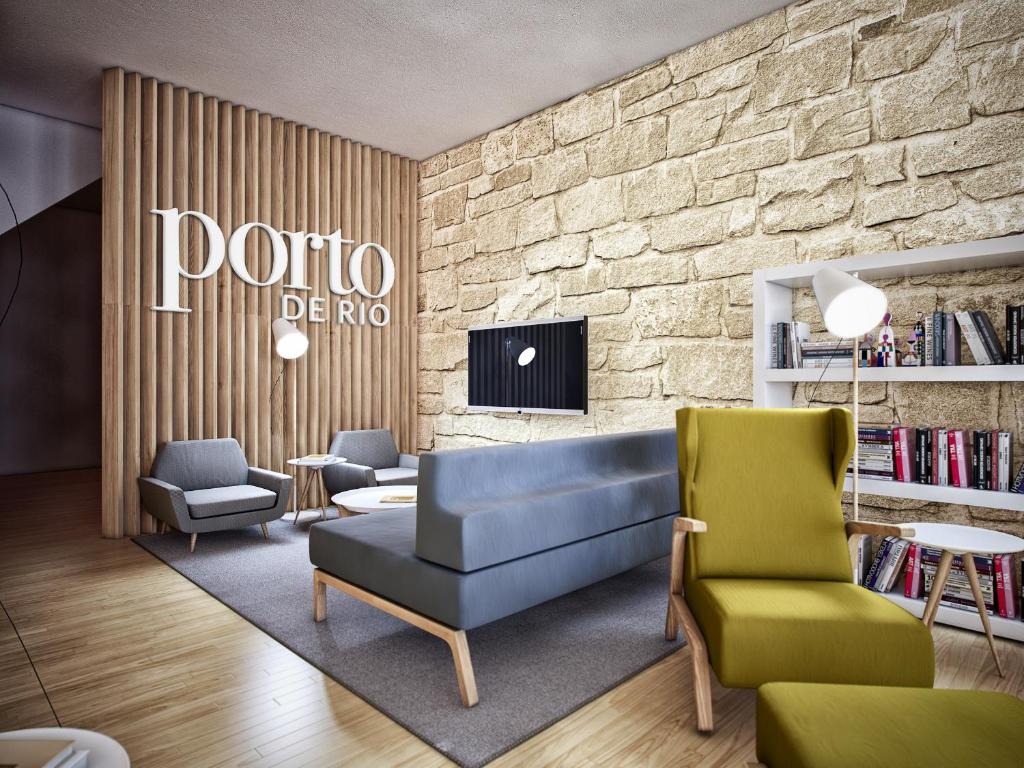 sala de estar con sofá azul y 2 sillas en GuestReady - Porto de Rio 3.2, en Oporto