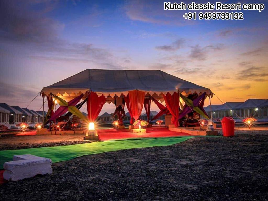 a tent with red and green lighting in a field at Kutch Classic Resort Camp in Dhordo