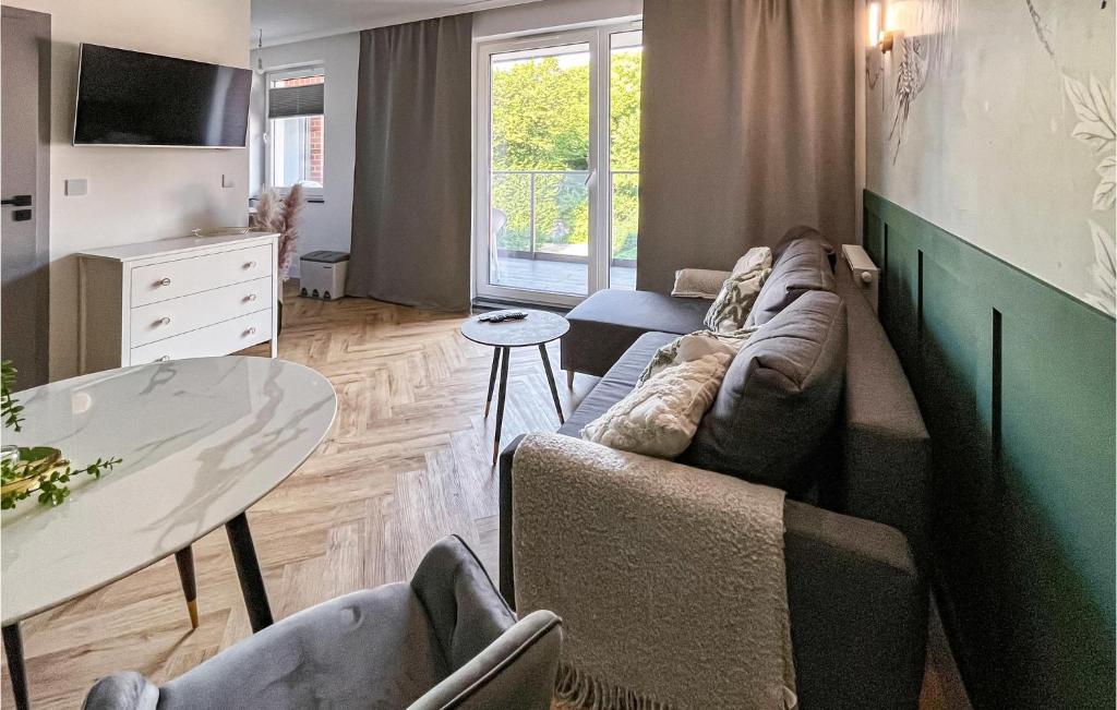 a living room with a couch and a table at 1 Bedroom Beautiful Apartment In Gdansk in Gdańsk