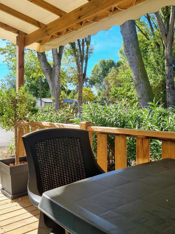 a table and chairs on a wooden deck at Mobile home De Luxe St Cyprien in Saint-Cyprien