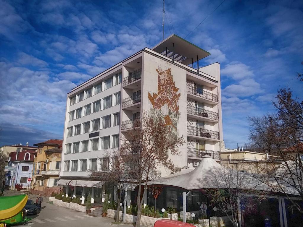 a large building with a clock on the side of it at Bononia Hotel in Vidin