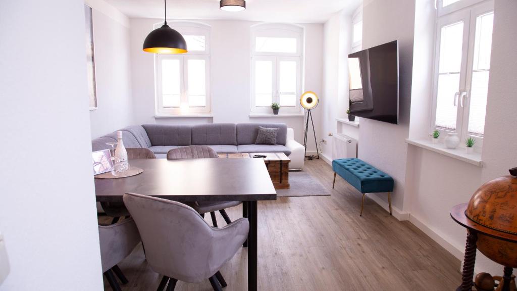 a living room with a table and a couch at Cityapartments am Hafen in Waren