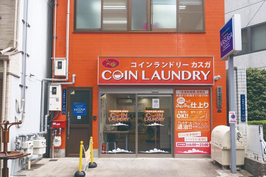 a building with a sign for a corn laundry at Sankei Hiranomachi Building - Vacation STAY 13206 in Osaka