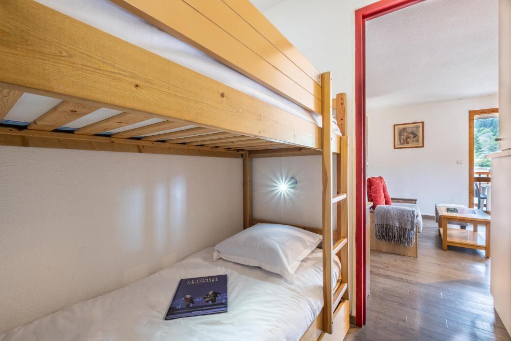 Кровать или кровати в номере Résidence Pierre & Vacances Les Ravines