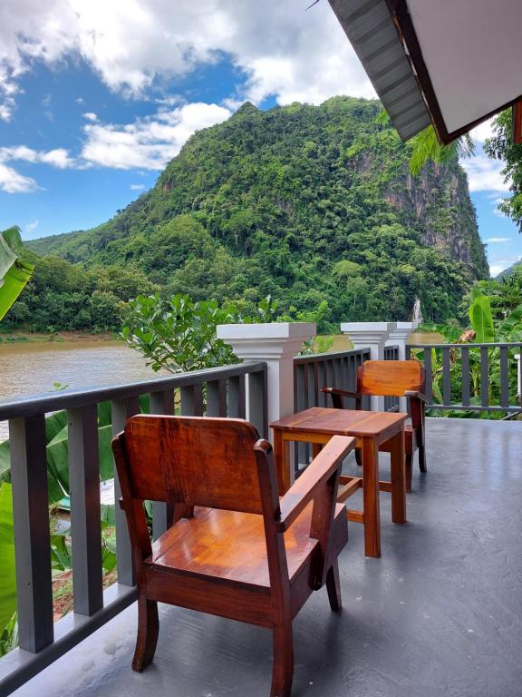a balcony with benches and a view of a mountain at Nam ou view villa in Nongkhiaw
