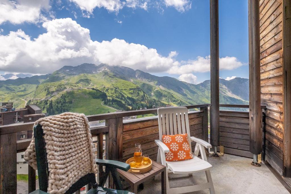 a balcony with two chairs and a view of a mountain at Résidence Pierre &amp; Vacances Electra in Avoriaz
