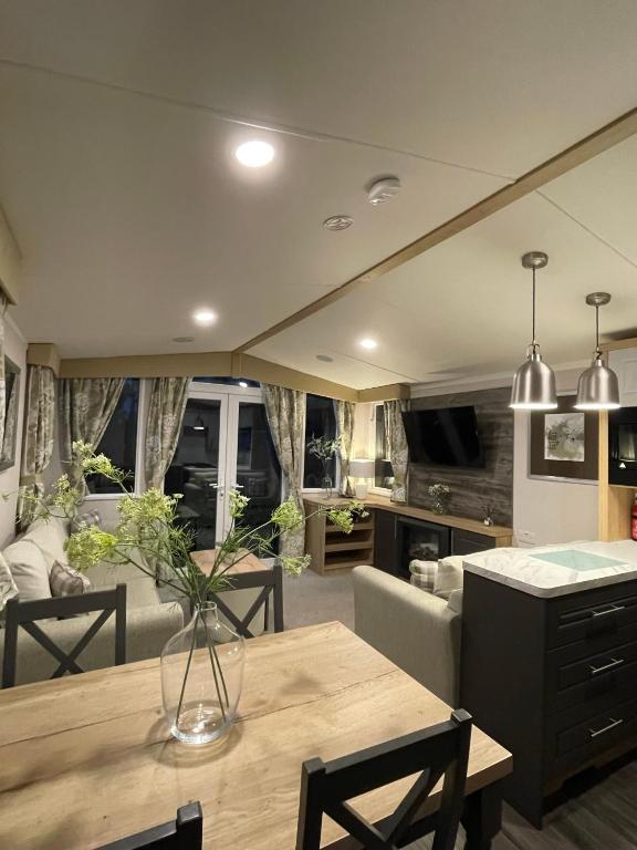 a living room with a table and a couch at PRESTIGE GOLF VILLAGE CARAVAN in Port Seton