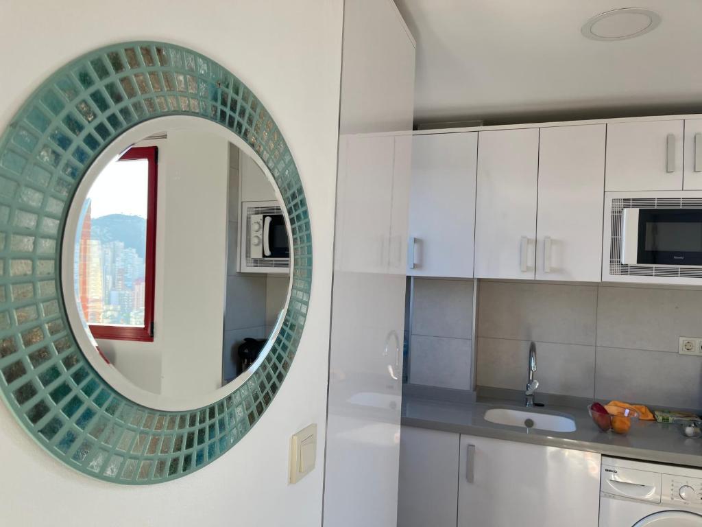 a bathroom with a mirror and a sink at Anna’s apartment in Benidorm