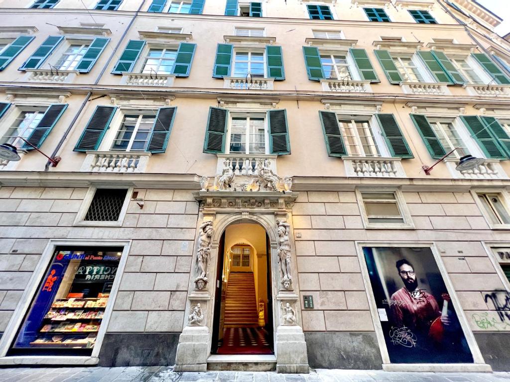 a large building with windows on a street at The Seven Residence in Genoa