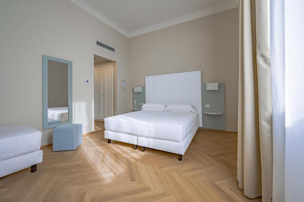 Postel nebo postele na pokoji v ubytování Hotel Ariele