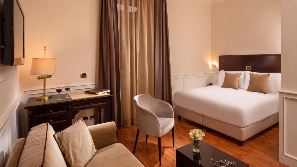 Postel nebo postele na pokoji v ubytování Hotel Del Corso