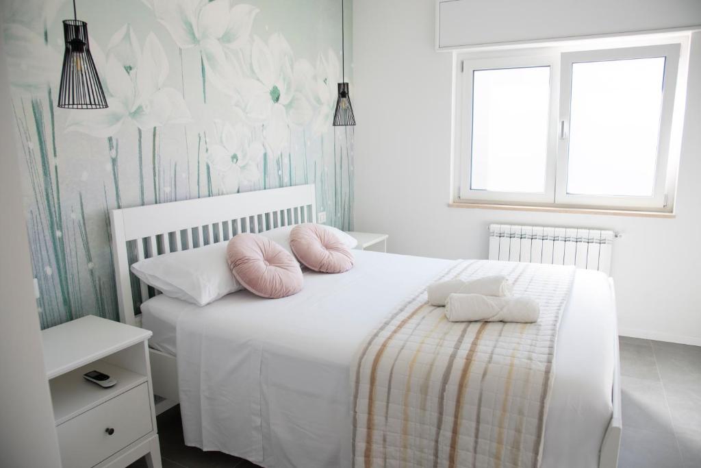 A bed or beds in a room at Perla Vacanza