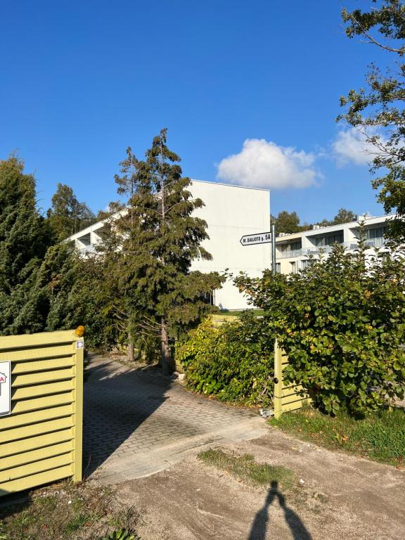 a shadow of a person standing in front of a building at Rugio namai-Rye house in Palanga