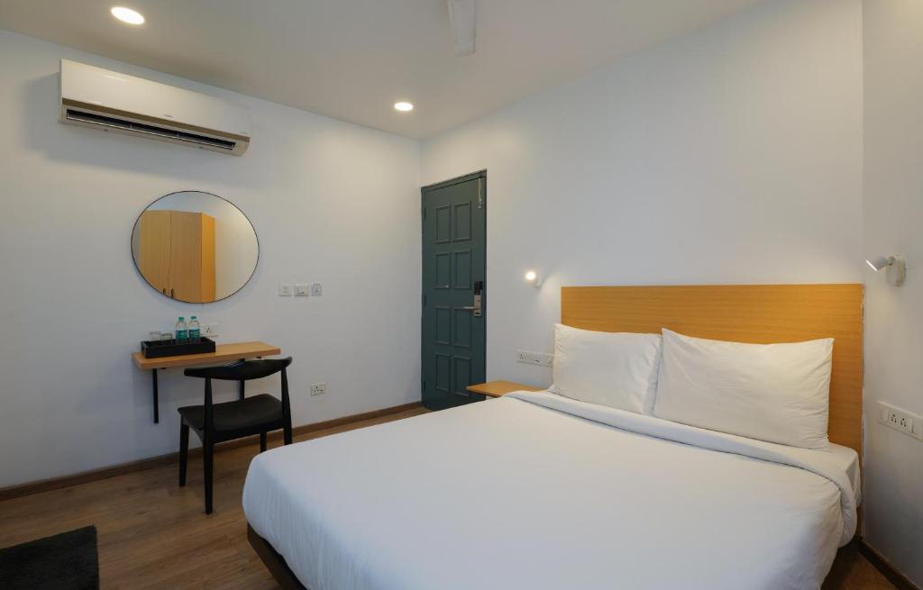 Postel nebo postele na pokoji v ubytování Uptown Hotel
