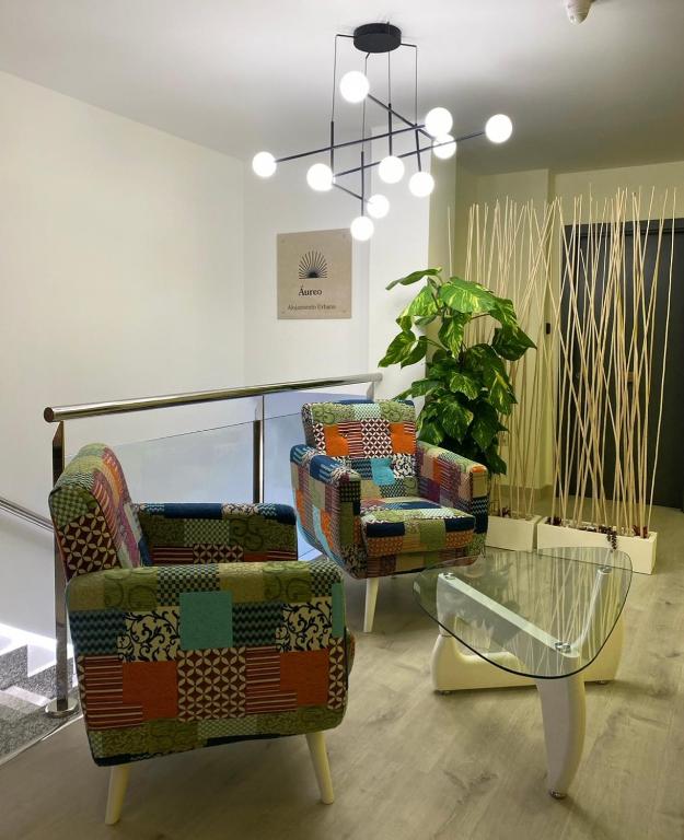 a room with two chairs and a glass table at Aureo Alojamiento Urbano in Abarán