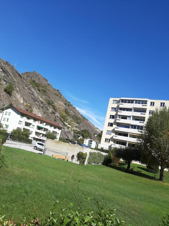 a park with a building and a grassy field at Casablanca in Sion