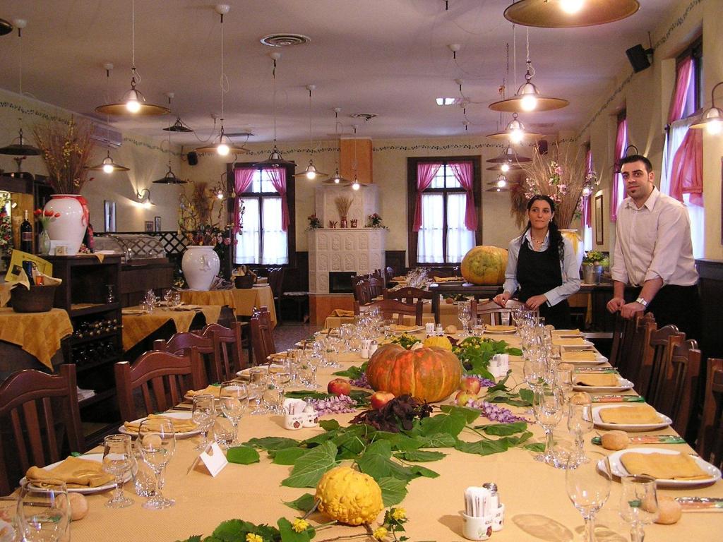 a man and woman standing in front of a table with pumpkins at Lataria dei Magredi in Vivaro