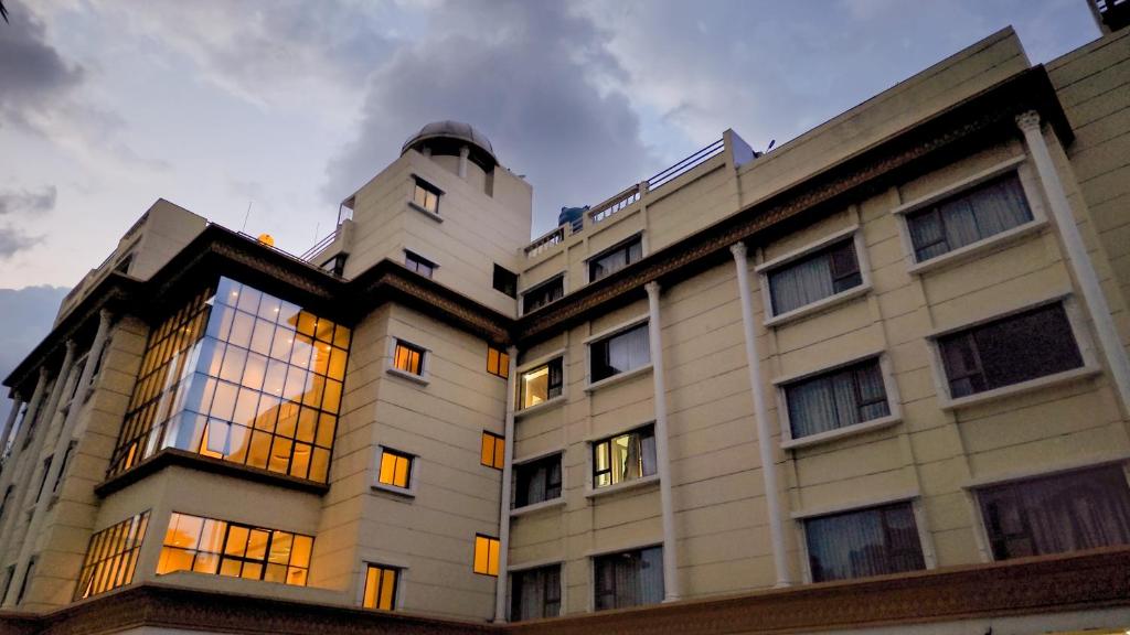 a white building with windows on the side of it at Hotel City Heart Shirdi in Shirdi