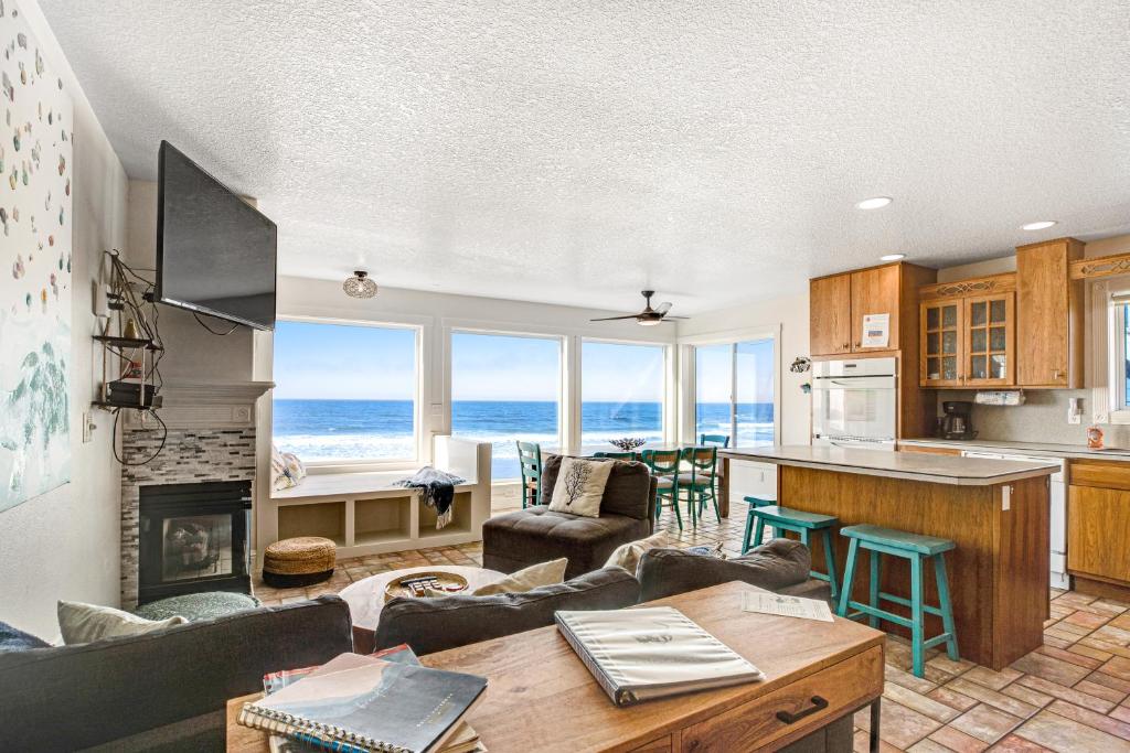 a kitchen and living room with a view of the ocean at Sand Castle 2 in Rockaway Beach