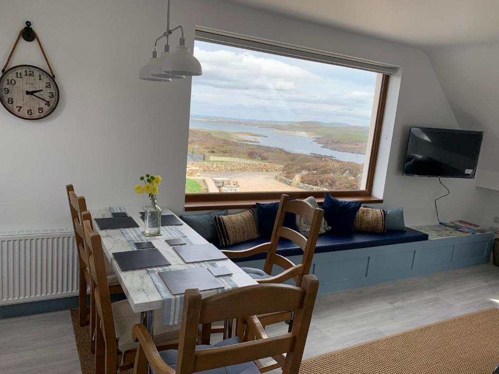 a dining room with a table and a large window at Blue Pearl Apartment in Downings