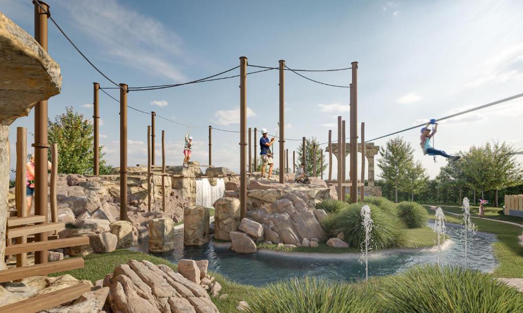 a rendering of a water park with people jumping in the air at City of Dreams Mediterranean - Integrated Resort, Casino & Entertainment in Limassol