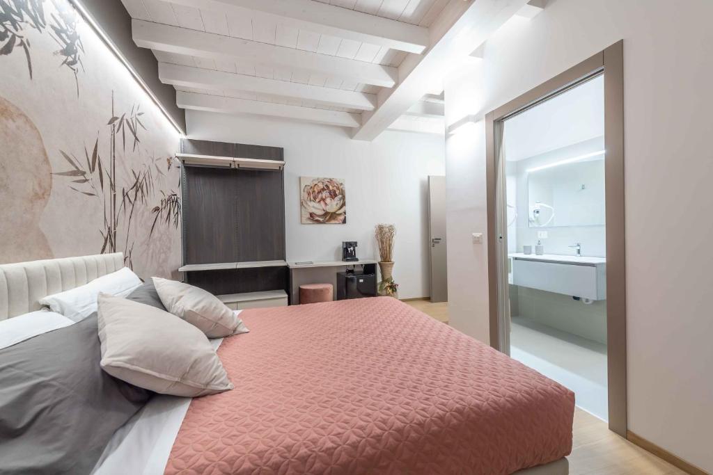 a bedroom with a large bed and a bathroom at Le Dimore in Ortona
