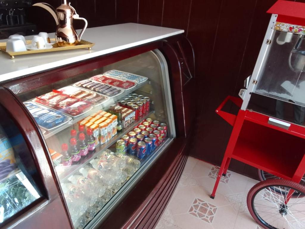 a refrigerator filled with lots of soda and drinks at Al Muhaidb Al Taif Hotel in Al Hada