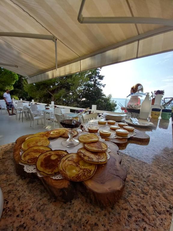 a wooden table with plates of food on it at Yasos Suites in Çeşme