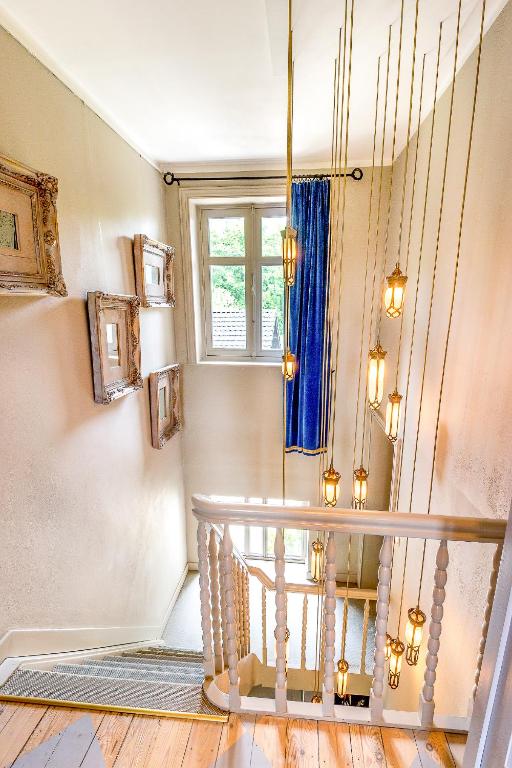 a staircase in a home with a blue curtain at Raesborre in Leuven